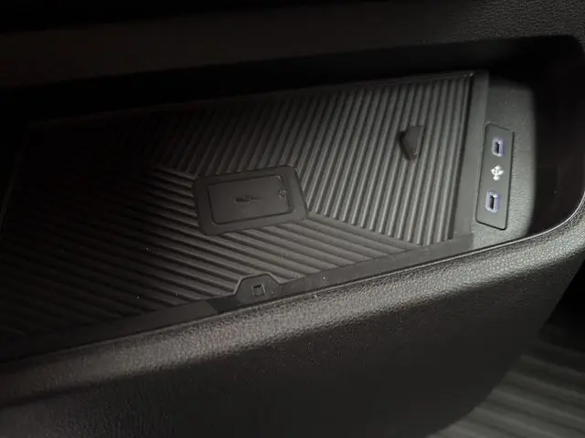 Gros plan sur le compartiment de rangement avec ports USB du Renault Master gris urbain, version 2025.