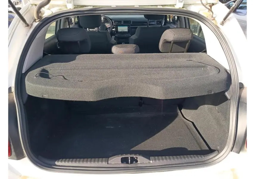 Coffre ouvert d’une Citroën C3 blanche 2021, vue arrière montrant l’espace de chargement et l’intérieur noir.