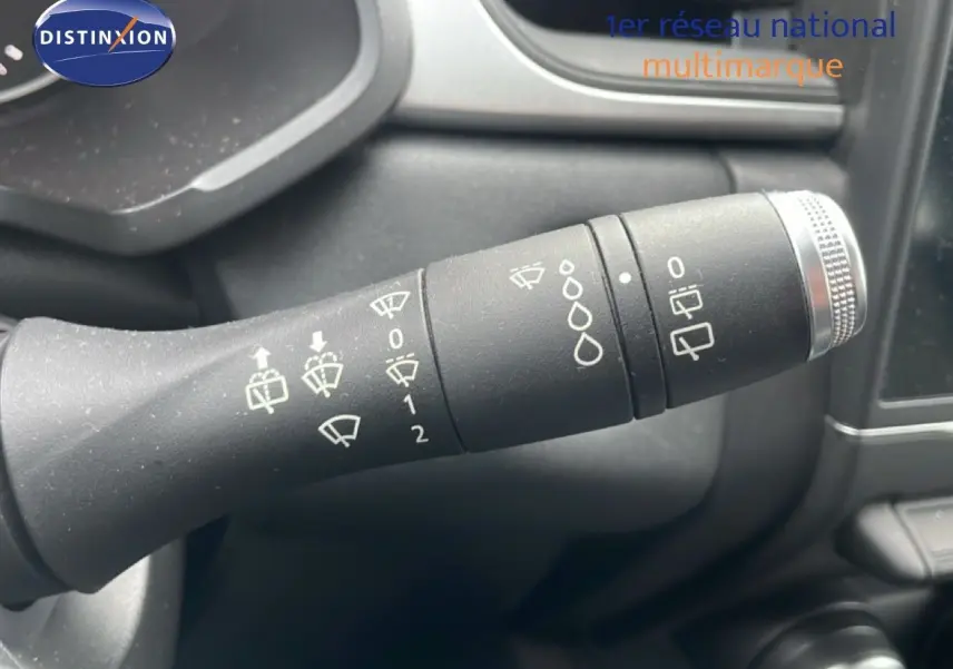 Gros plan sur la commande d’essuie-glace du Renault Captur gris Cassiopée, montrant les réglages et symboles blancs.