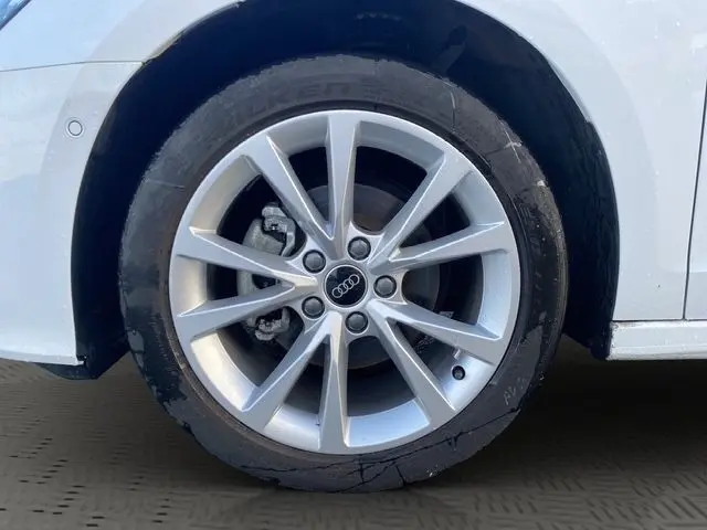 Gros plan sur la roue avant droite blanche d'une Audi A3 30 TFSI 116 MHEV 2024 avec jante alu à dix branches.