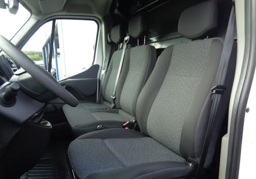 Intérieur du fourgon Opel Movano L3H2 2022, vue côté conducteur montrant les sièges en tissu gris noir.