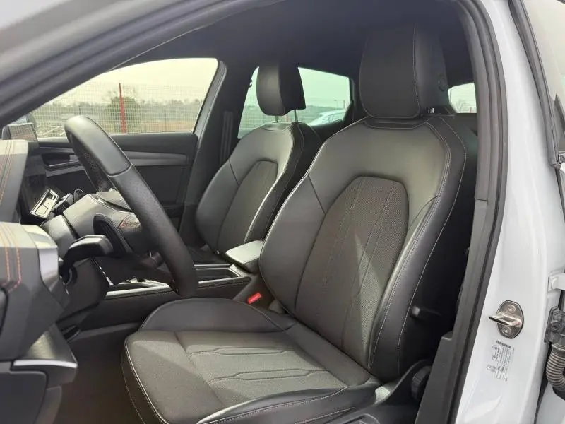 Vue intérieure côté conducteur du CUPRA Formentor 2025 blanc Nevada, sièges en cuir noir avec surpiqûres contrastantes.