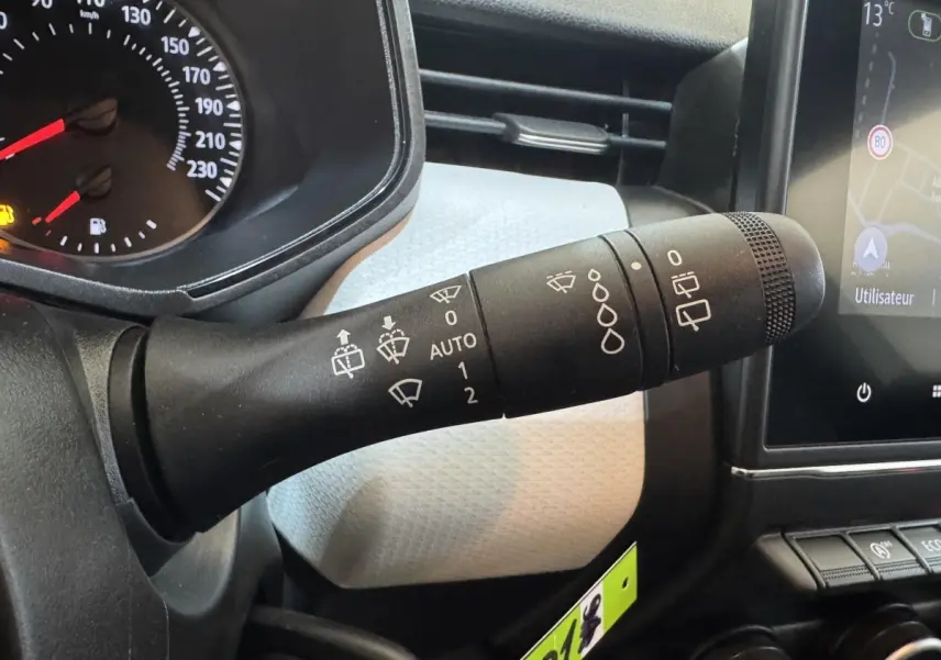 Gros plan sur la manette d’essuie-glace côté gauche du tableau de bord de la Renault Clio Business blanche 2023.