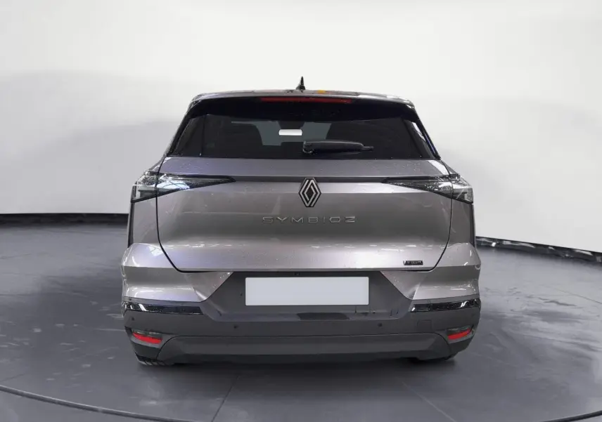 Vue arrière d’un Renault SYMBIOZ gris cassiopée 2025 avec feux étirés et logo central lumineux.