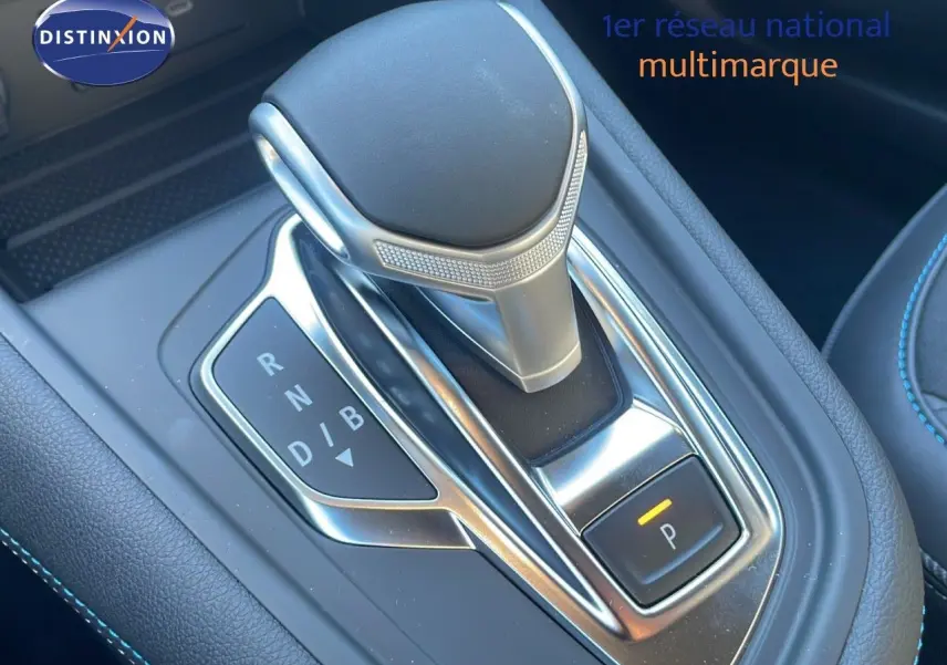 Le levier de vitesses automatique du Renault Captur E-Tech hybride 2025 en gros plan avec surpiqûres bleues.