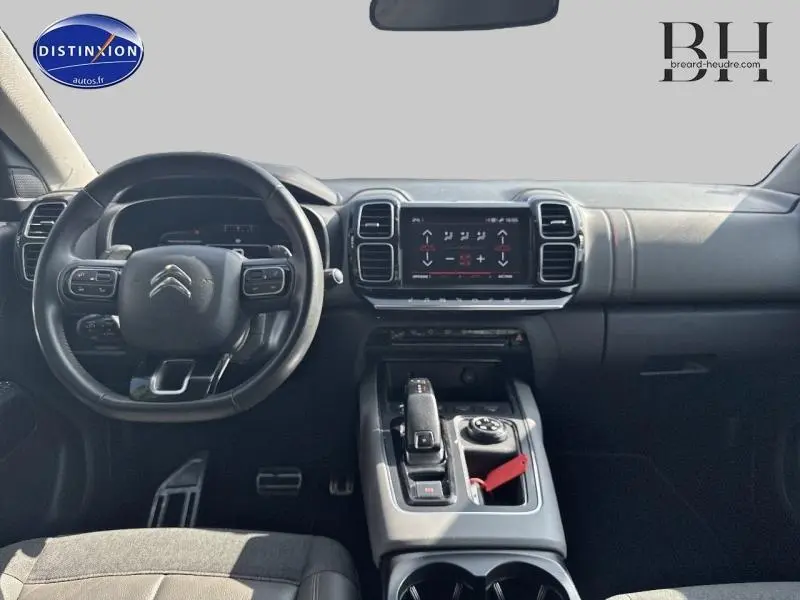 Vue intérieure avant du Citroën C5 Aircross 2020, tableau de bord et volant en cuir noir avec console centrale moderne.