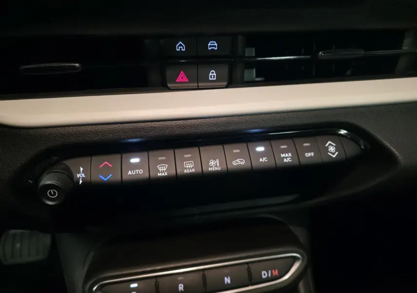 Vue rapprochée de la console centrale de la Fiat 600 rouge 2024, montrant les commandes de climatisation et la boîte auto.