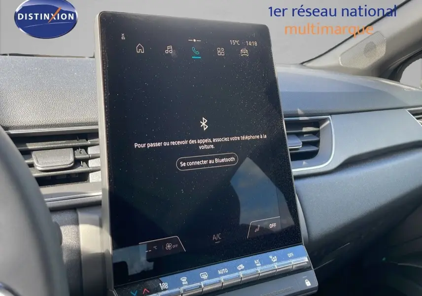 Vue intérieure centrée sur l'écran tactile du tableau de bord du Renault Captur noir étoile métal avec toit gris.