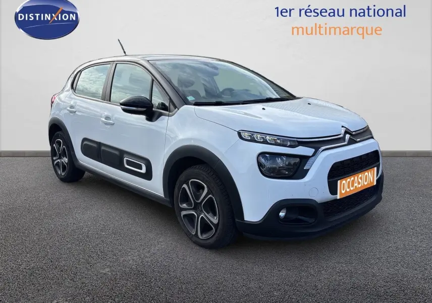 Citroën C3 blanc banquise vue 3/4 avant droit avec protections latérales noires et jantes stylisées.