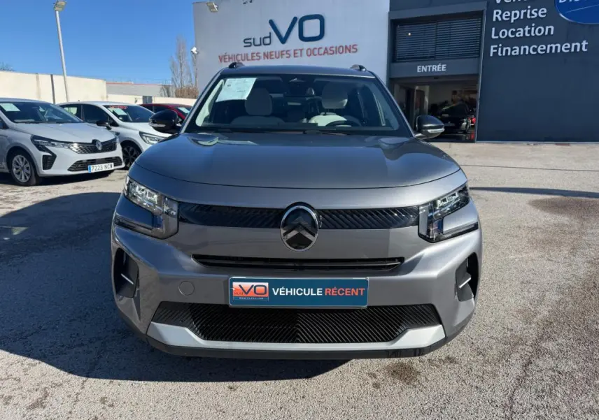 Vue avant d'une Citroën C3 Turbo 100 ch gris 2025 avec barres de toit et jantes alliage 17 pouces, stationnée en extérieur.