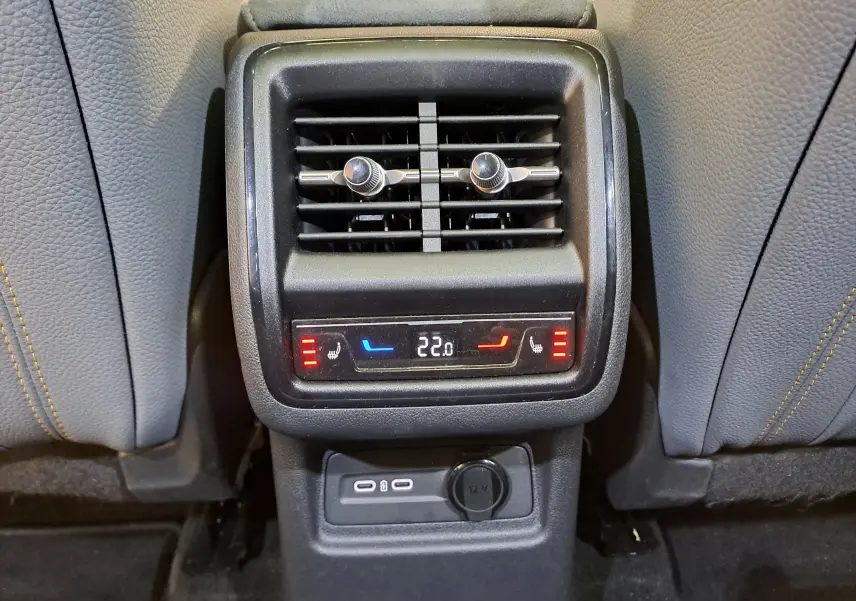 Vue rapprochée de la console arrière du Skoda Kodiaq gris graphite, montrant la ventilation, commandes de chauffage et ports USB.