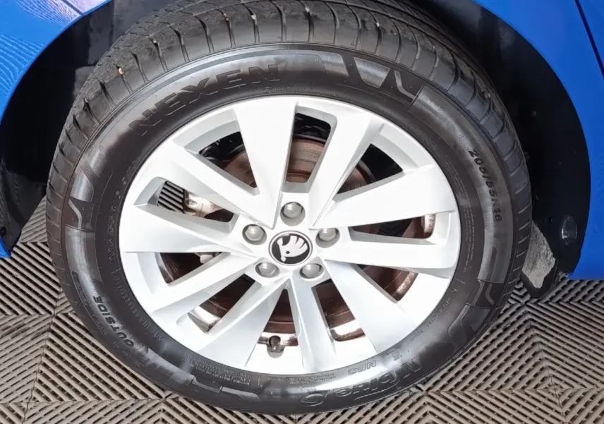 Gros plan sur la roue avant droite d’une Skoda Scala bleu 2025 avec jante alliage argentée et pneu Nexen.