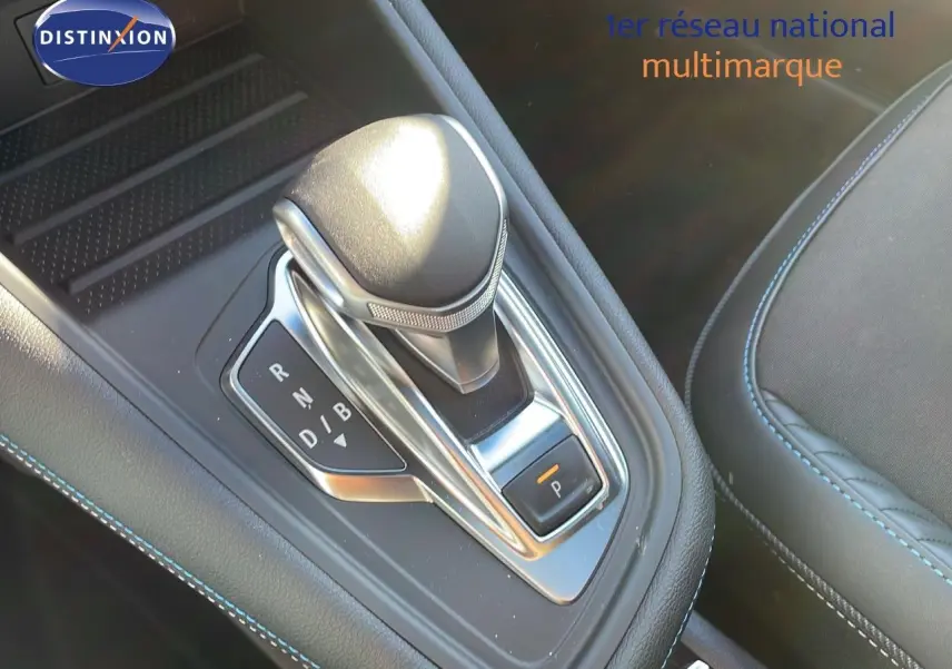 Le levier de vitesse automatique du Renault Captur E-Tech hybride, entouré de coutures bleues sur la console noire.