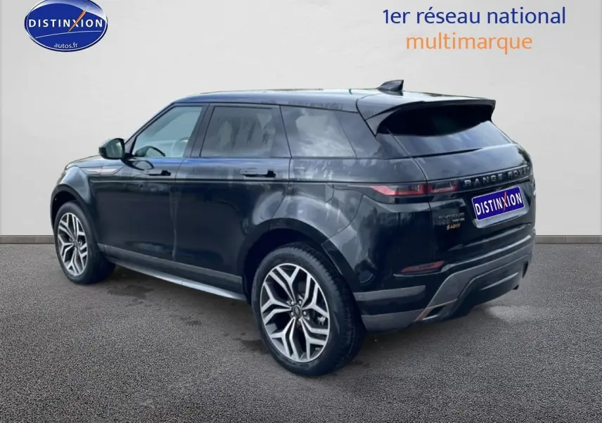 Range Rover Evoque noir vu en 3/4 arrière droit, avec jantes alliage et toit panoramique visible.