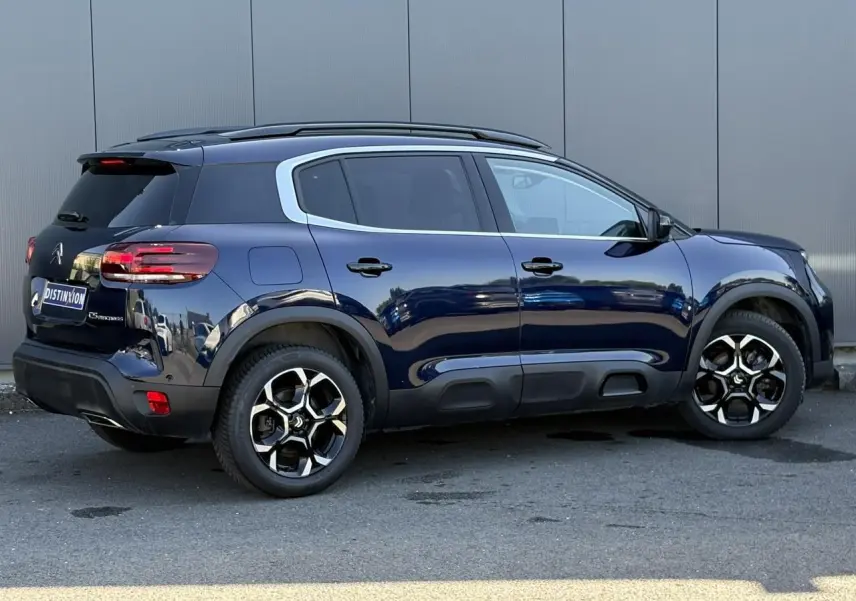 Vue latérale droite du Citroën C5 Aircross Hybrid bleu Eclipse avec jantes alliage et protections noires sur bas de caisse.