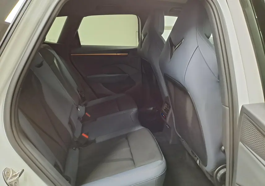 Vue intérieure arrière côté droit du CUPRA TERRAMAR blanc Nevada, montrant les sièges arrière et les finitions modernes.