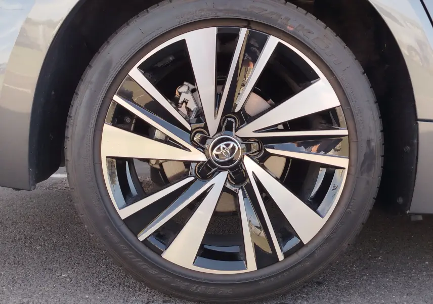 Gros plan sur la jante bi-ton noire et argentée d’une Toyota Corolla Touring Sport Gris Atlas, roue avant droite.