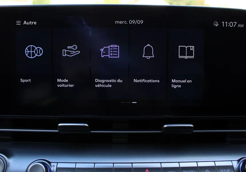 Écran tactile central du Hyundai Kona 2024 affichant les options Sport, Mode voiturier, Diagnostic, Notifications et Manuel en ligne.
