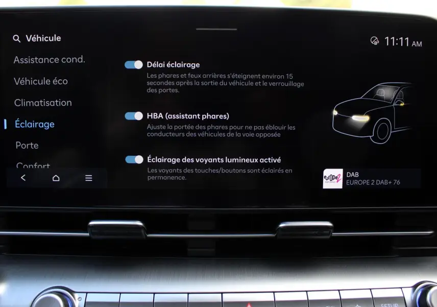 Écran tactile intérieur du Hyundai Kona 2024 affichant les réglages d’éclairage et l’assistant phares.