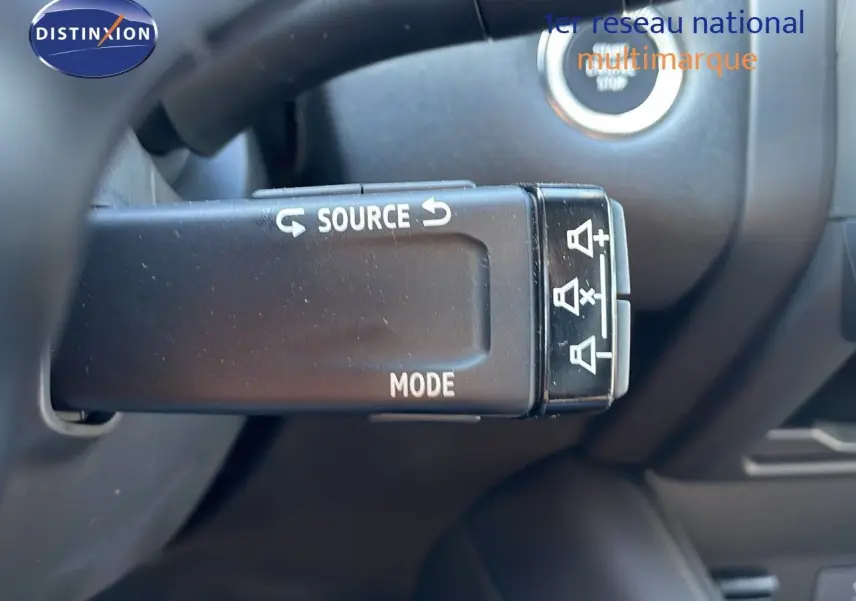Commande au volant avec boutons source et mode du Renault Captur E-Tech hybride 2025, intérieur noir.