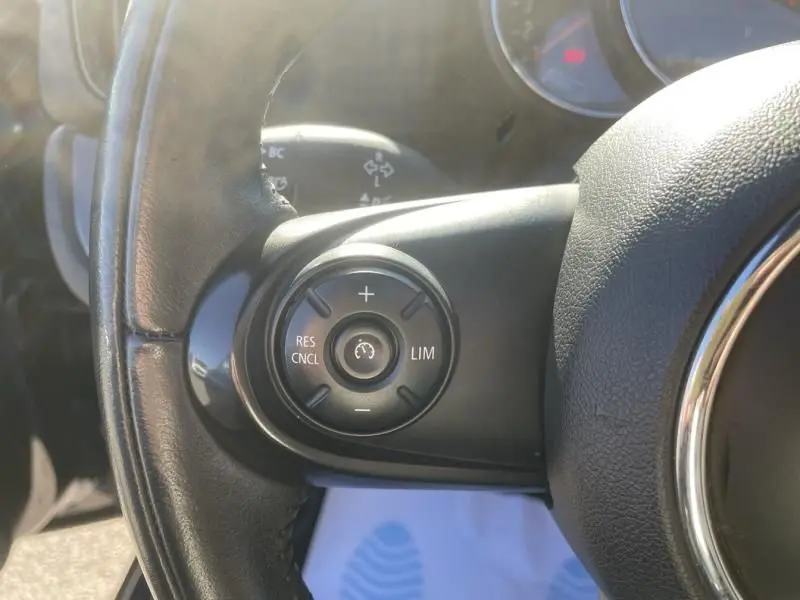 Gros plan sur les commandes de régulateur de vitesse au volant d’un MINI Countryman bleu de 2018.