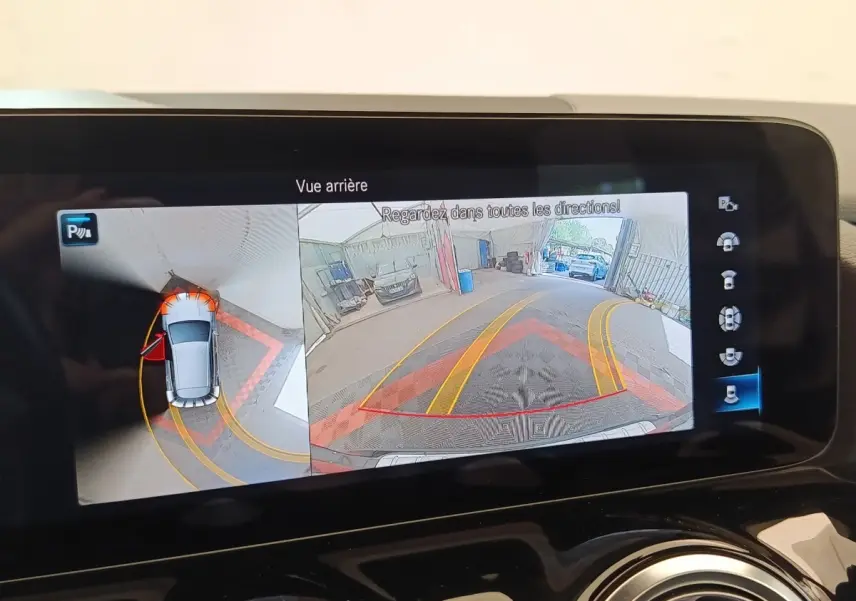 Écran multimédia montrant la caméra de recul et vue 360° du Mercedes GLA 250 e AMG Line noir en stationnement.