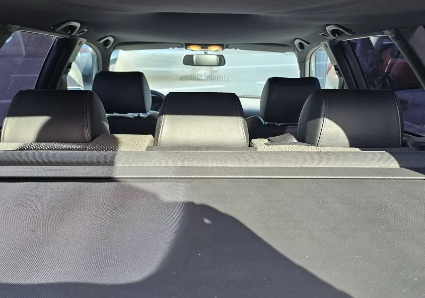 Vue arrière intérieure de l'Audi RS4 Avant grise de 2001, montrant les appuie-têtes noirs et la plage arrière.