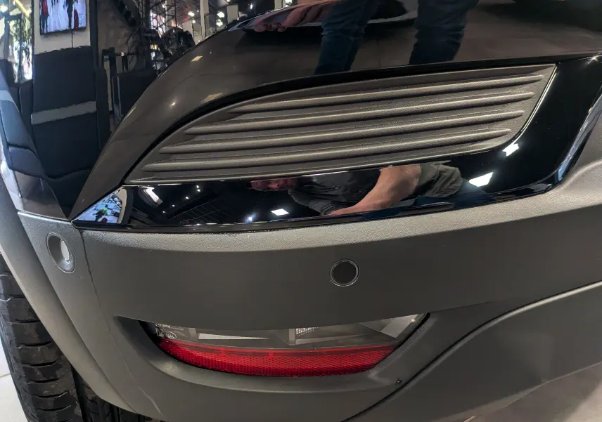 Gros plan sur le feu arrière droit noir et gris du Renault Captur E-TECH 2026, avec capteur de stationnement visible.