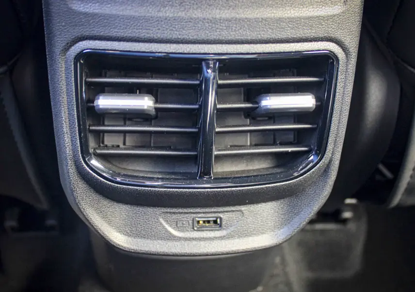 Gros plan sur la sortie d'air arrière noire et la prise USB du MG3 1.5L HYBRID+ 195CH LUXURY 2026 en intérieur.