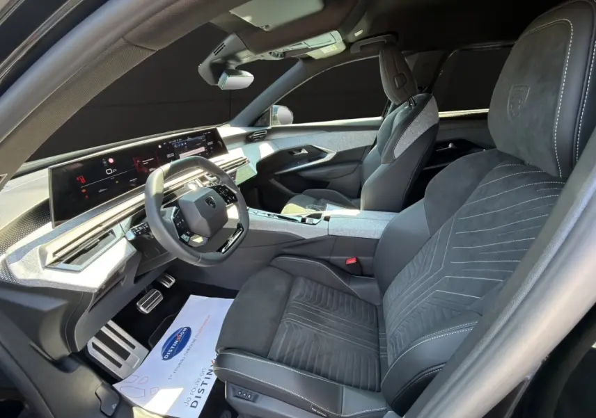 Intérieur avant droit du Peugeot 5008 noir 2025, sellerie Alcantara grise avec tableau de bord numérique panoramique.