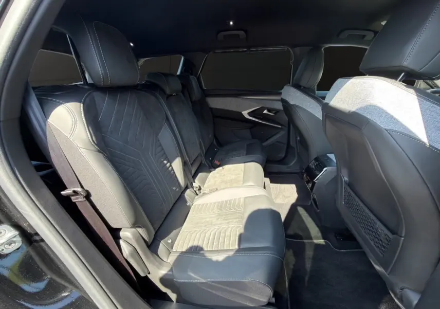 Vue intérieure côté gauche des sièges arrière en cuir et alcantara noirs du Peugeot 5008 2025 avec sellerie Alcantara.