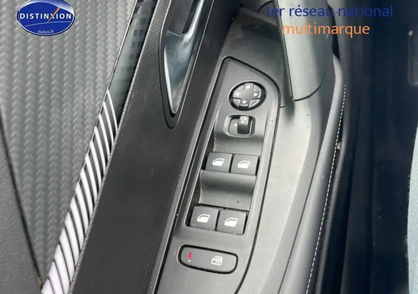 Détail de la commande des vitres électriques côté gauche dans l’habitacle du Peugeot 2008 gris sélénite.