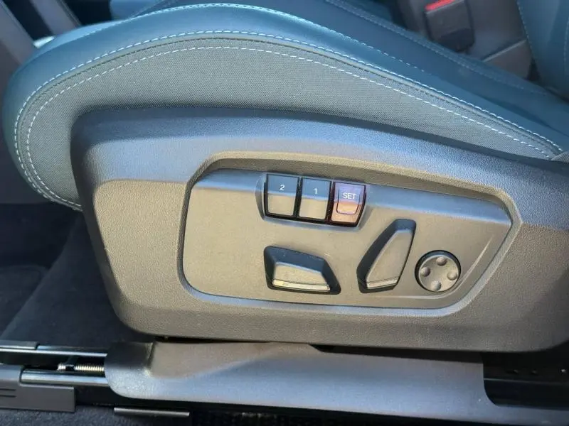 Réglages électriques des sièges côté gauche du MINI COUNTRYMAN 2024 en finition Midnight Black II, avec mémoire de position.