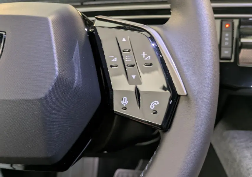 Gros plan sur la partie droite du volant du Peugeot 5008 2025, avec commandes vocales et téléphone intégrées.