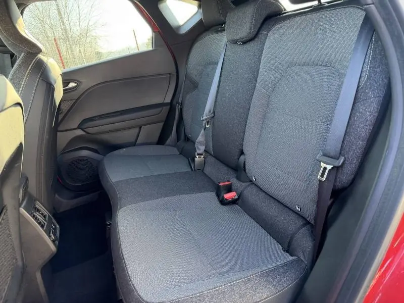 Vue intérieure côté droit des sièges arrière gris foncé du Renault Captur 2025 Rouge Flamme/Noir Étoilé.