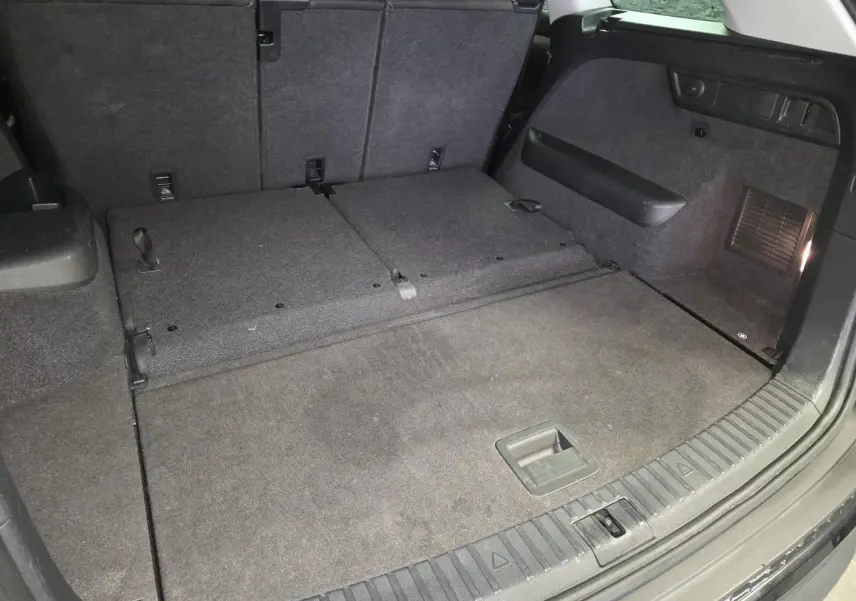 Coffre noir spacieux du Skoda Kodiaq 2023 vu de l'arrière avec banquette arrière rabattue et revêtement tissu.