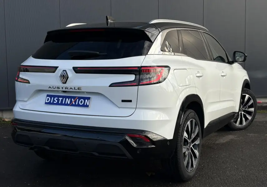 Vue 3/4 arrière droite d'un Renault Austral blanc nacré avec toit noir étoilé et jantes alliage 19 pouces.