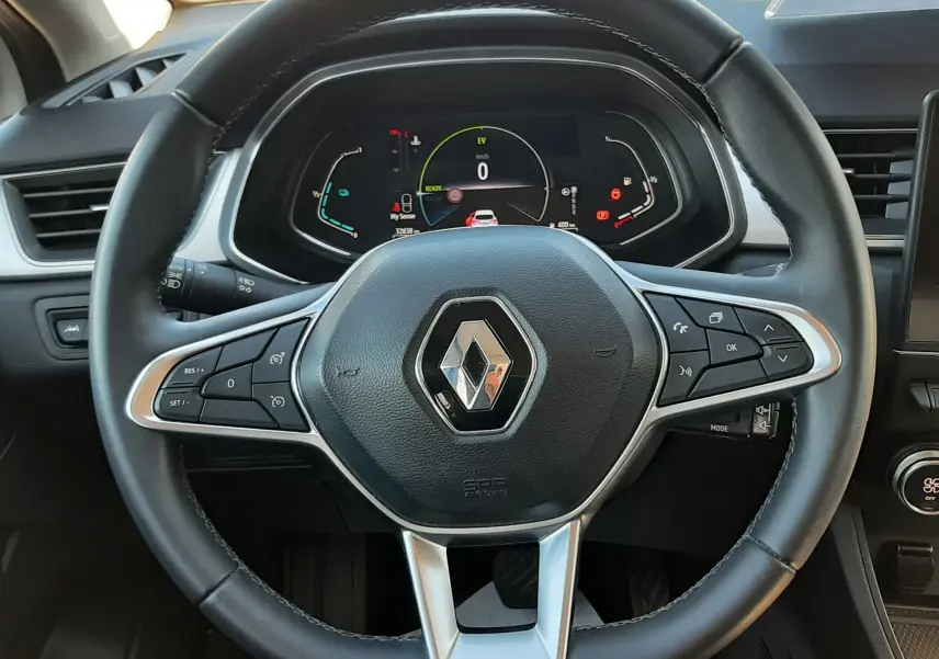 Vue rapprochée du volant noir de la Renault Captur E-Tech 145ch Intens 2022 avec tableau de bord numérique allumé.