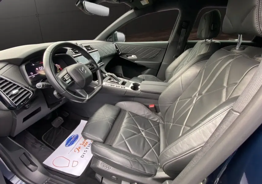 Vue intérieure côté conducteur du DS7 Crossback 2024, sièges cuir noir matelassé et tableau de bord moderne.