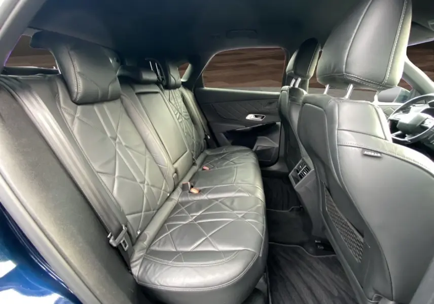 Vue intérieure côté droit des sièges arrière en cuir noir du DS7 Crossback Bleu, avec détails matelassés et accoudoirs.