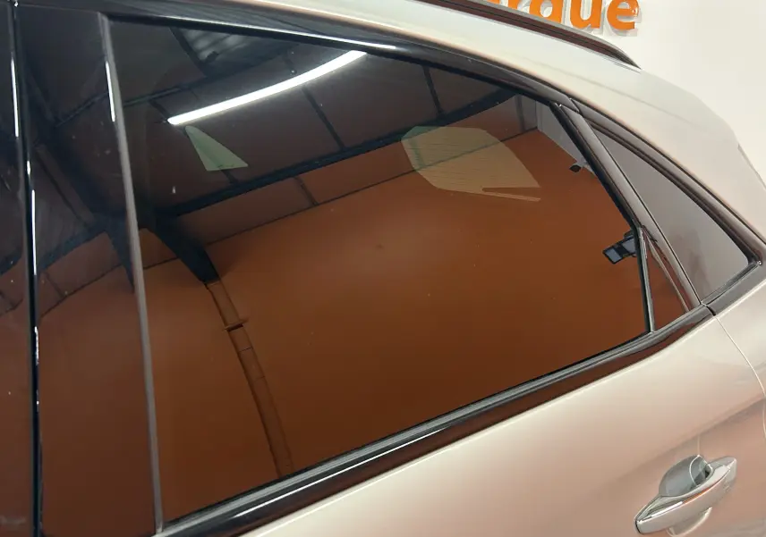 Vue latérale droite sur la porte arrière d’un DS7 2024 Cristal Pearl avec vitre teintée et poignée chromée.