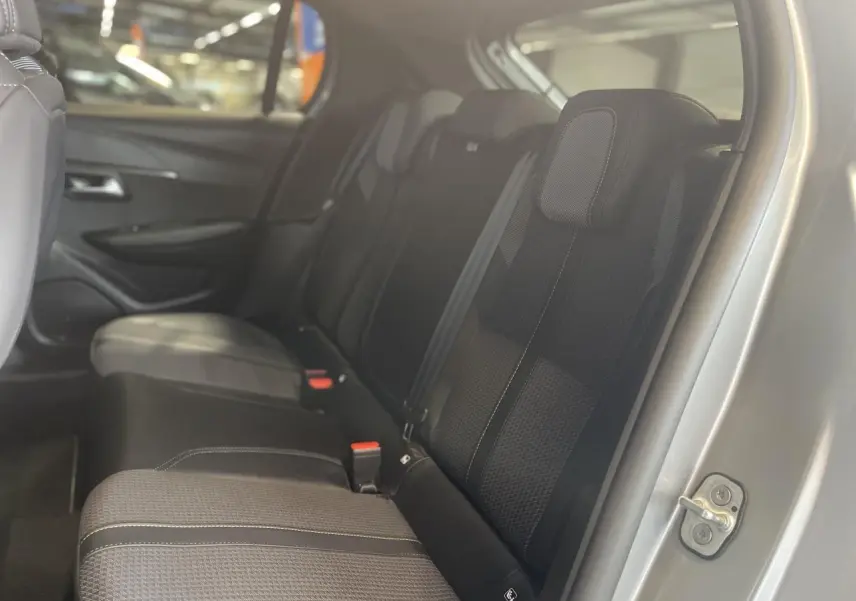 Vue intérieure côté droit sur la banquette arrière noire de la Peugeot 208 gris clair métallisé.
