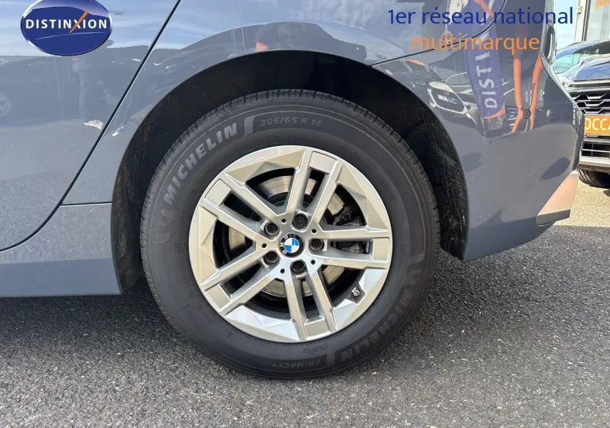 Gros plan sur la roue arrière droite d'une BMW Série 2 Active Tourer gris cuivré avec jante alliage 16 pouces.