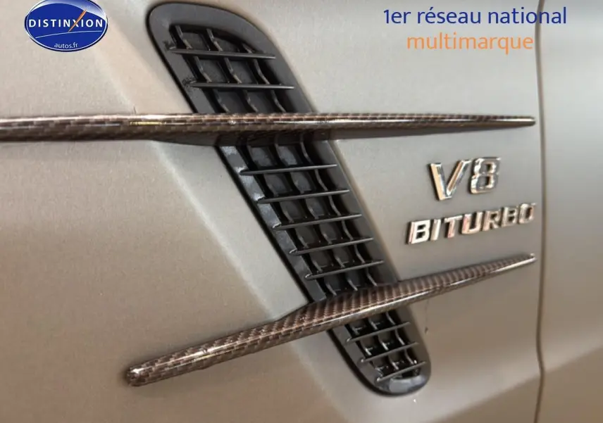 Détail de l'aération latérale droite en carbone et logo V8 BITURBO sur carrosserie grise d'une Mercedes Classe SL 63 AMG.