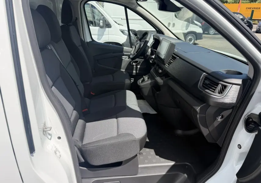 Vue intérieure côté droit du Renault Trafic Fourgon blanc 2025, montrant les sièges avant et le tableau de bord moderne.