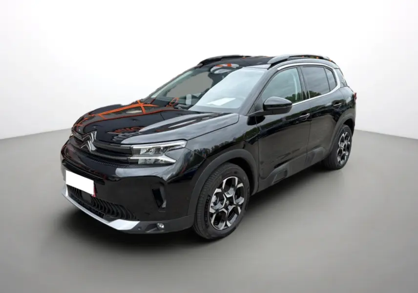 Citroën C5 Aircross noir métallisé vue 3/4 avant droit avec jantes alu et barres de toit visibles.