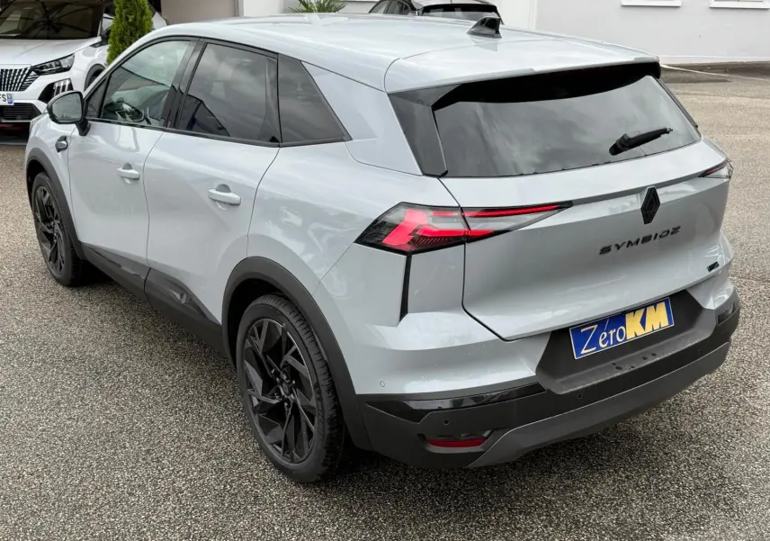 Vue 3/4 arrière droite du Renault Symbioz gris Rafale avec feux arrière LED et jantes noires distinctives.