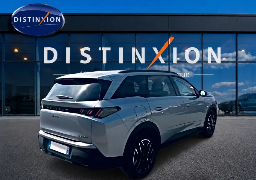 Peugeot 5008 Hybrid 145 allure e-dcs6 gris artense, vue 3/4 arrière droit avec jantes alu et vitres surteintées.