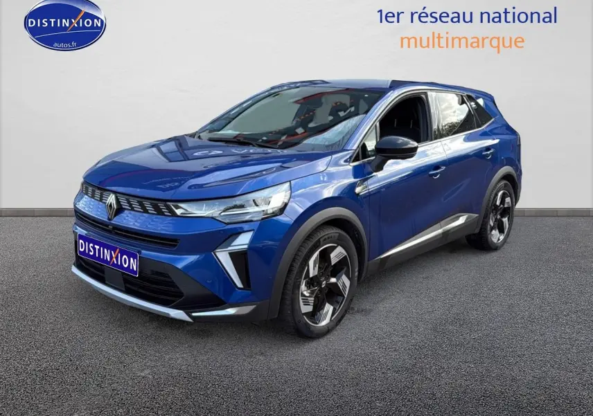 Renault Symbioz bleu iron metal en 3/4 avant droit, SUV hybride avec barres de toit et jantes stylisées.