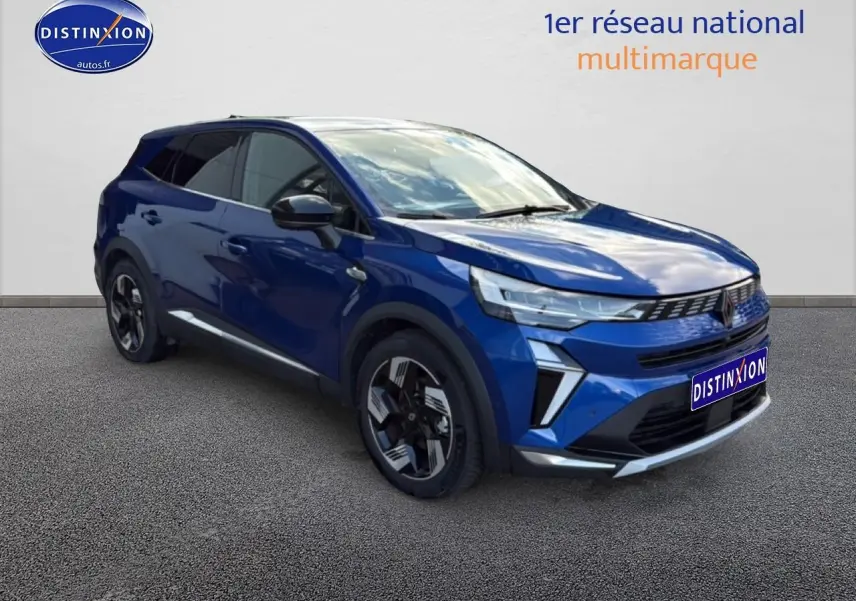 Renault Symbioz bleu iron metal en 3/4 avant droit, avec jantes modernes et calandre distinctive.